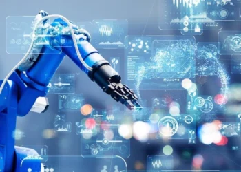 A blue robotic arm is performing a task surrounded by various holographic digital interfaces displaying data and graphs. The background is a blurred industrial or laboratory setting with multicolored lights, highlighting the advanced technology and automation of smart robots in action. | 5StarsStocks