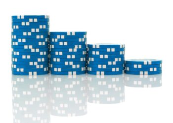 A series of blue and white Blue Chip poker chips stacked in descending order from left to right against a white background. The stacks reflect on the shiny surface below them. | 5StarsStocks