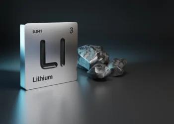 A graphic representation of lithium stocks is depicted with the element's symbol "Li", atomic number "3", and atomic weight "6.941" on a metallic square panel. Beside it, three pieces of rough lithium ore are displayed against a dark gradient background. | 5StarsStocks