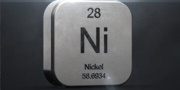 A metallic cube with shiny edges depicts the chemical element Nickel, with the symbol "Ni," atomic number 28, and atomic weight 58.6934 engraved on its front face. The background is dark, and the top left and bottom right corners are illuminated, reminiscent of fluctuating Nickel stocks in a dynamic market. | 5StarsStocks