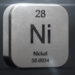 A metallic cube with shiny edges depicts the chemical element Nickel, with the symbol "Ni," atomic number 28, and atomic weight 58.6934 engraved on its front face. The background is dark, and the top left and bottom right corners are illuminated, reminiscent of fluctuating Nickel stocks in a dynamic market. | 5StarsStocks