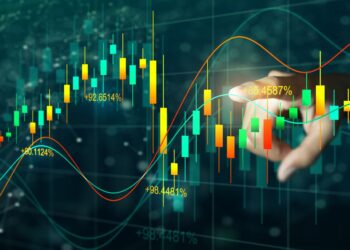 A hand touches a digital screen displaying a colorful financial graph with fluctuating candlestick patterns and percentage data, representing market trends and analysis of high dividend stocks. The background is dark with a network of data points and lines. | 5StarsStocks