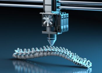 A 3D printer is creating a detailed model of a human spine. The scene is lit with a blue hue, highlighting the intricate vertebrae structure being printed layer by layer. This innovative technology continues to capture the interest of those investing in 3D printing stocks. | 5StarsStocks