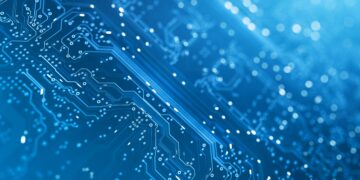 A close-up of a blue circuit board with intricate pathways and tiny embedded components. The background is filled with light bokeh, creating a futuristic and high-tech feel. The image emphasizes the complexity and precision reminiscent of leading technology stocks. | 5StarsStocks