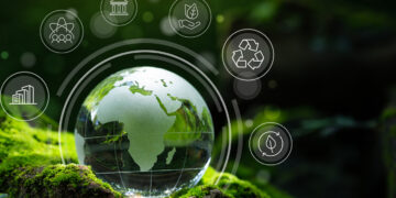 A glass globe depicting Africa rests on a bed of moss, surrounded by nature-themed icons including recycling, renewable energy, and sustainable practices, symbolizing environmental conservation and socially responsible investing in a lush, green environment. | 5StarsStocks
