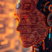 Futuristic humanoid robot with a transparent face casing displaying lines of code and text, glowing in orange and red tones. The background features an array of abstract, blurred circuitry and technology elements from 5StarsStocks AI, adding to the high-tech atmosphere. | 5StarsStocks