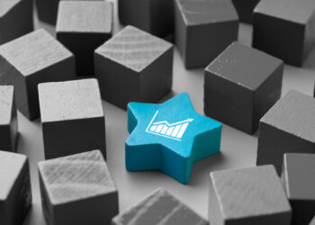 A blue star-shaped block with a white graph icon, symbolizing the best dividend stocks, stands out among a group of gray cube-shaped blocks. | 5StarsStocks