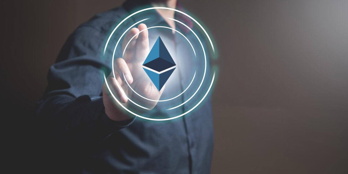 A person in a dark shirt is touching a glowing digital Ethereum logo surrounded by concentric circles, symbolizing interaction with cryptocurrency or blockchain technology. | 5StarsStocks