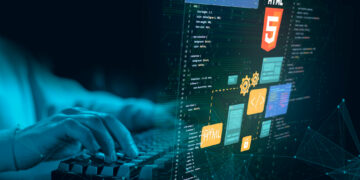 A person types on a keyboard with a digital overlay showing HTML5 icons, code snippets, and web development graphics, symbolizing tech programming and web design. The scene has a blue-green tech-inspired theme. | 5StarsStocks