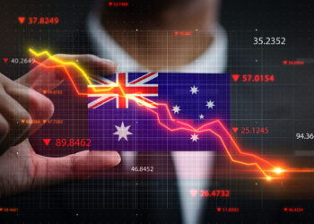 A person points at a downward-trending stock chart superimposed over the Australian flag, with various financial numbers and red indicators suggesting a decline in the Australian market. | 5StarsStocks