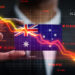 A person points at a downward-trending stock chart superimposed over the Australian flag, with various financial numbers and red indicators suggesting a decline in the Australian market. | 5StarsStocks