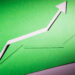 Two green paper arrows pointing upward symbolize growth or progress, set against a green background with shadows emphasizing the cut-out shapes. | 5StarsStocks