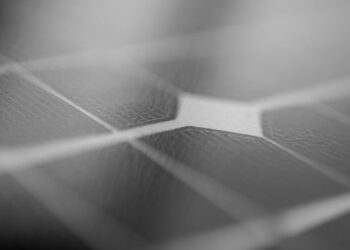 Detailed monochrome close-up of a solar panel surface showing texture and grid pattern.